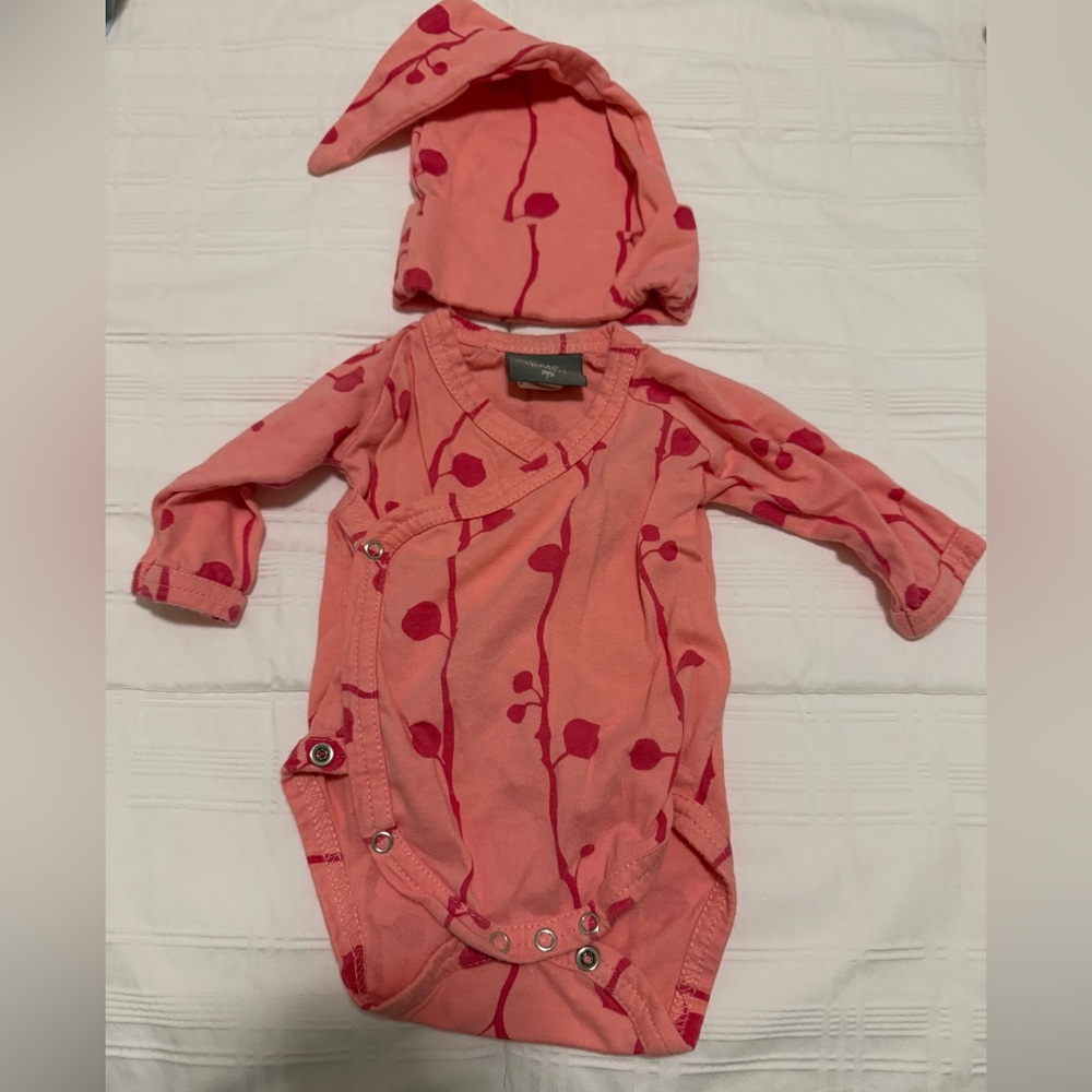 Kate Quinn Pink and Red Bodysuit with Playful Patterns and Matching Hat